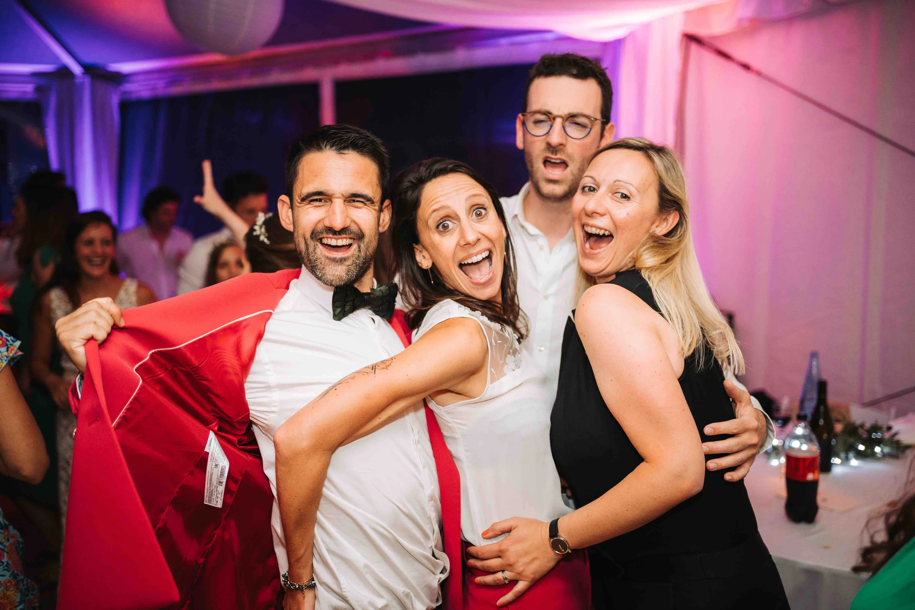 Quatre invités serrés les uns contre les autres à la fin de la soirée